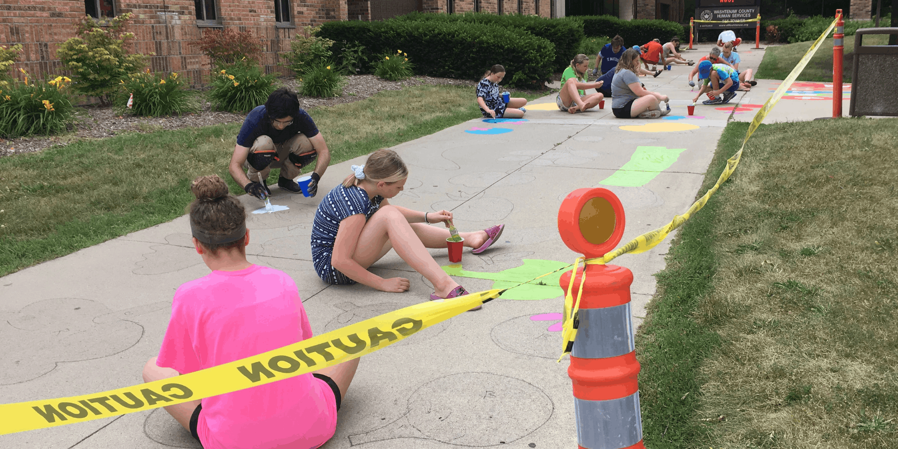 people working on the mural